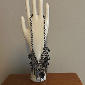 Costume jewelry. Large necklace with lots of layered chains and baubles.